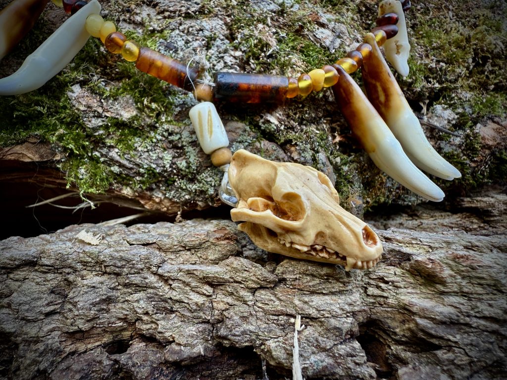 Amber bead necklace with wolf teeth and wolf skull
